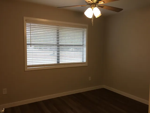 a view of a room with a window and wooden floor
