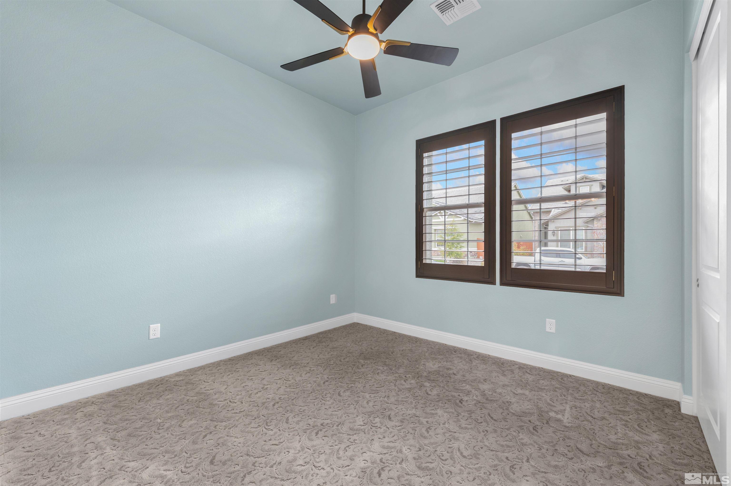 9404 Flying Horse Road Reno, NV 89521 - Photo 27 of 40 an empty room with ceiling fan and windows