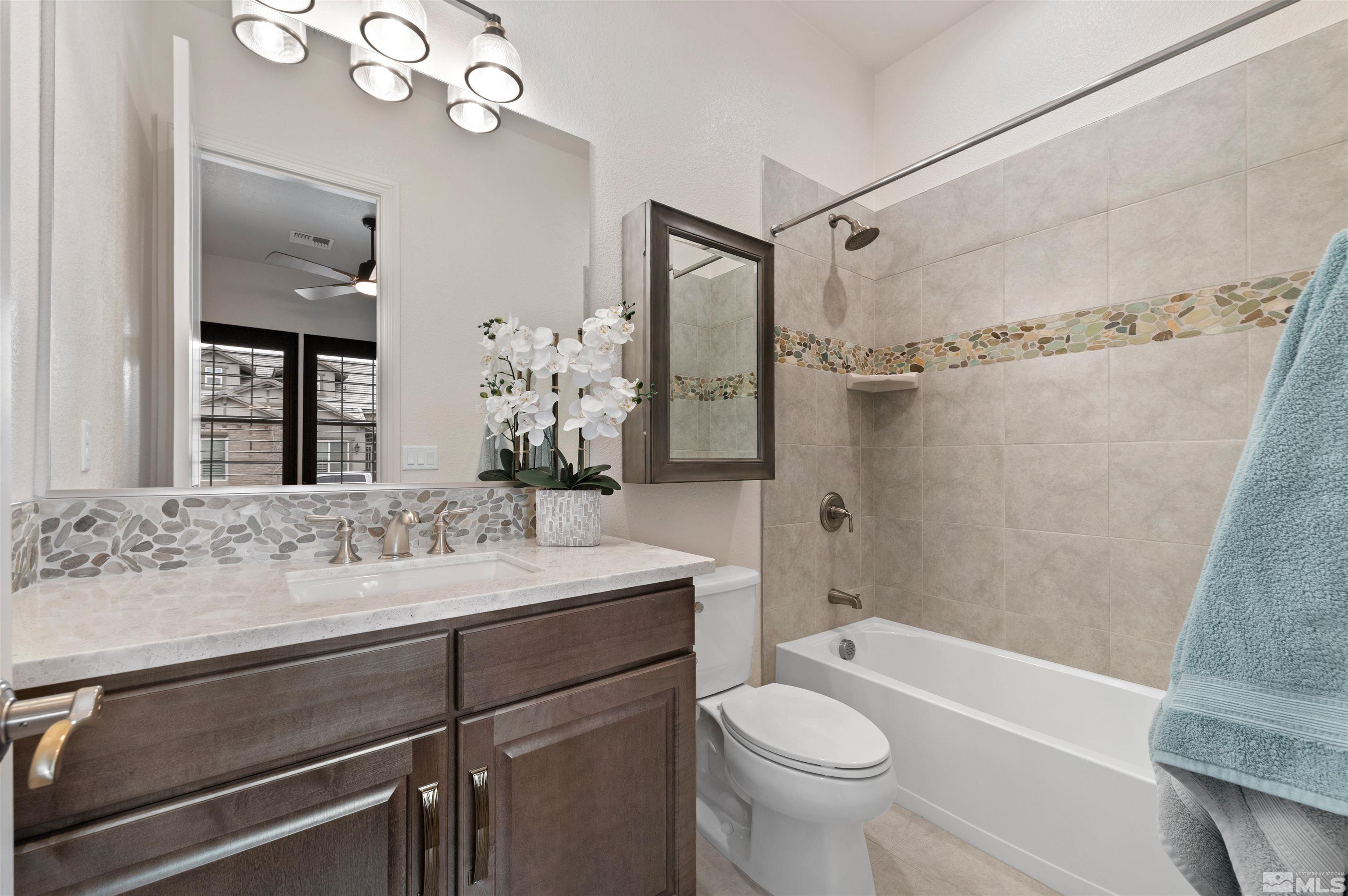 9404 Flying Horse Road Reno, NV 89521 - Photo 29 of 40 a bathroom with a sink a toilet and shower