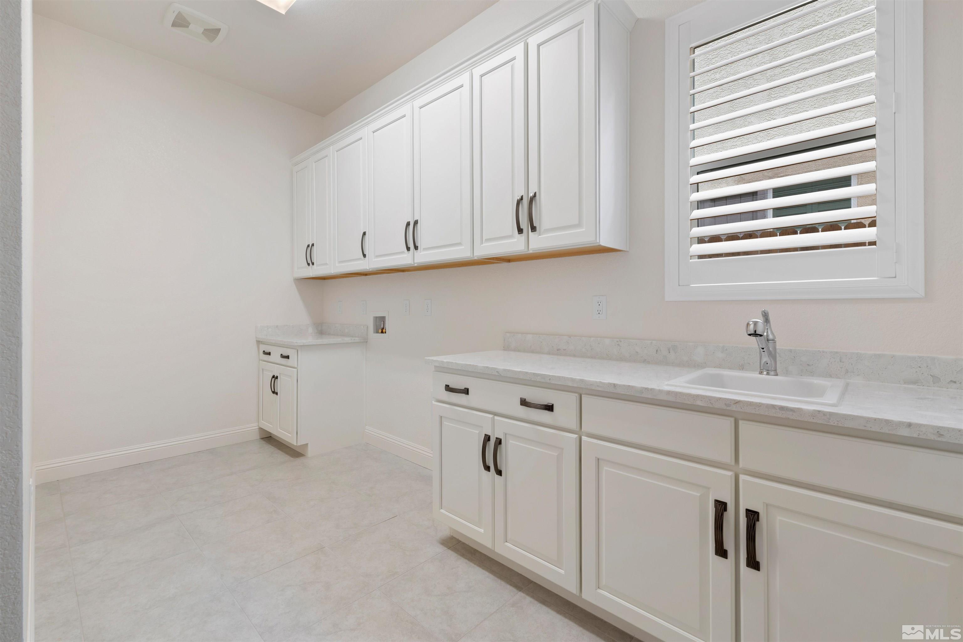 9404 Flying Horse Road Reno, NV 89521 - Photo 34 of 40 a kitchen with white cabinets and a sink