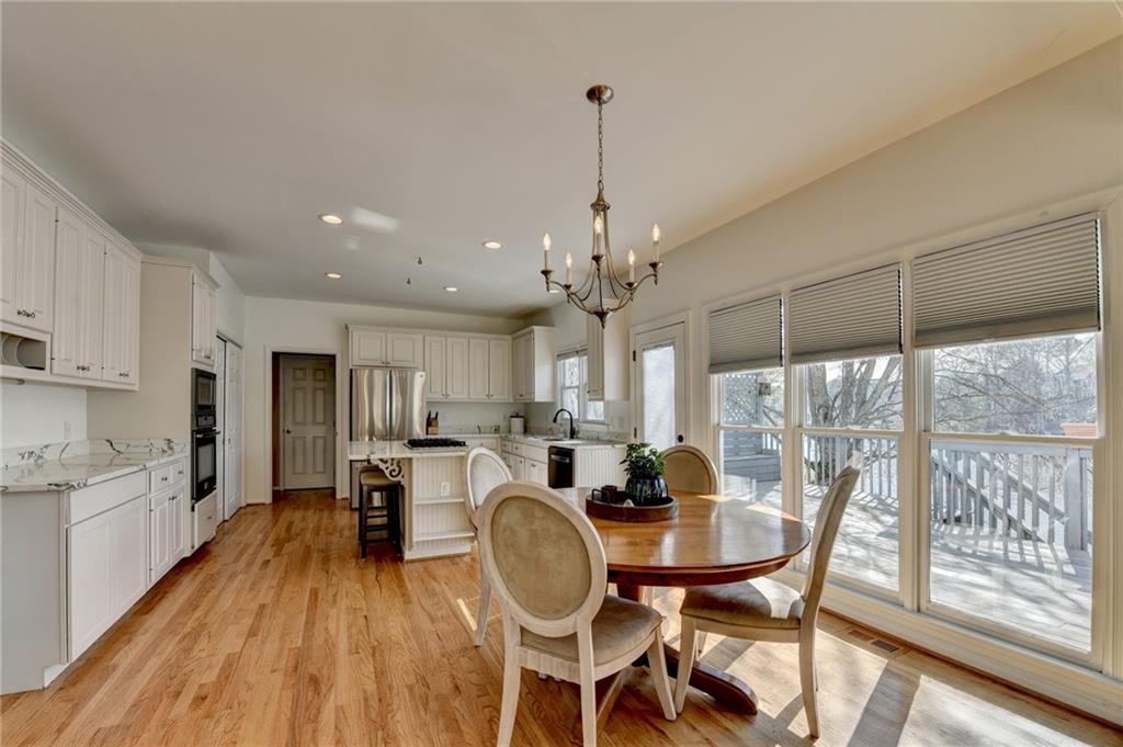 2152 Merrymount Drive Suwanee, GA 30024 - Photo 11 of 63 a dining room with furniture a chandelier and wooden floor