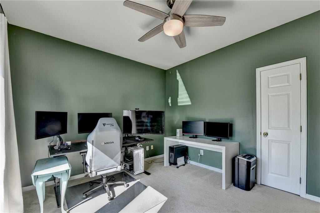 2152 Merrymount Drive Suwanee, GA 30024 - Photo 17 of 63 a view of a workspace with furniture and a ceiling fan