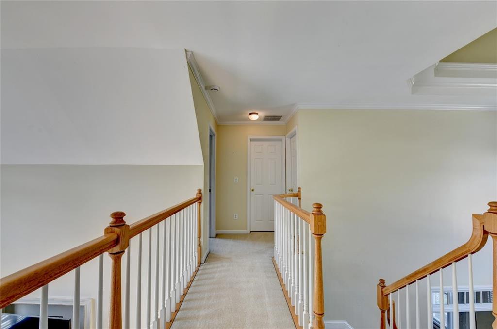 2152 Merrymount Drive Suwanee, GA 30024 - Photo 18 of 63 a view of a hallway with wooden floor and stairs