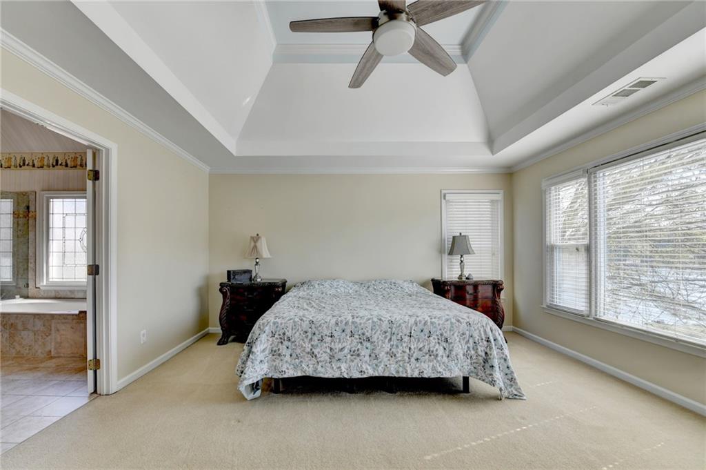 2152 Merrymount Drive Suwanee, GA 30024 - Photo 21 of 63 a bedroom with a bed a dresser and a large window