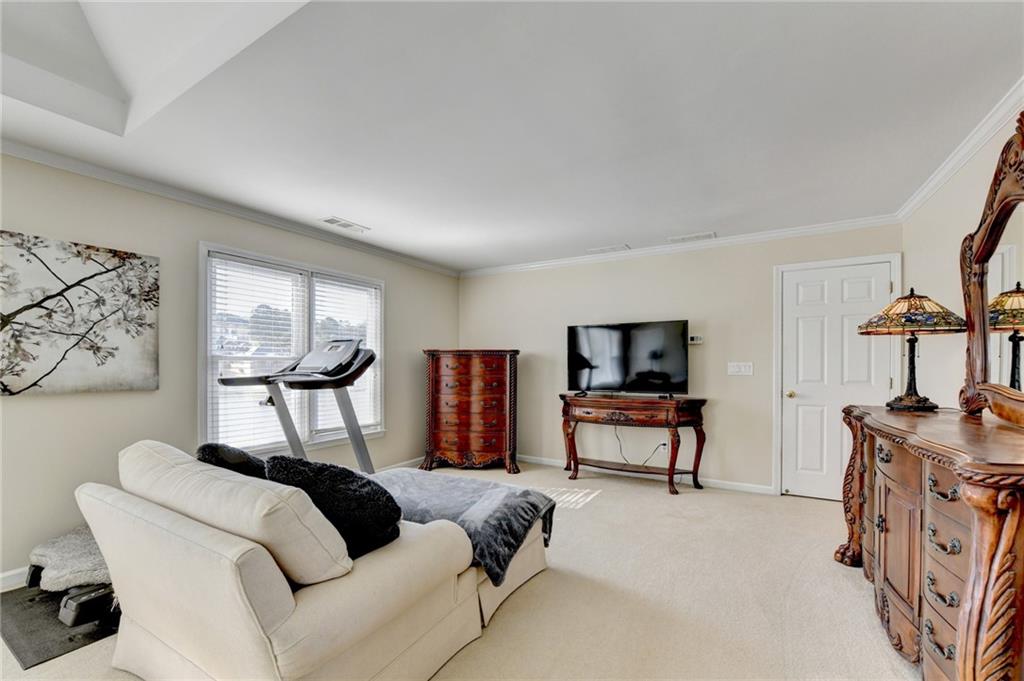 2152 Merrymount Drive Suwanee, GA 30024 - Photo 22 of 63 a living room with furniture and a flat screen tv