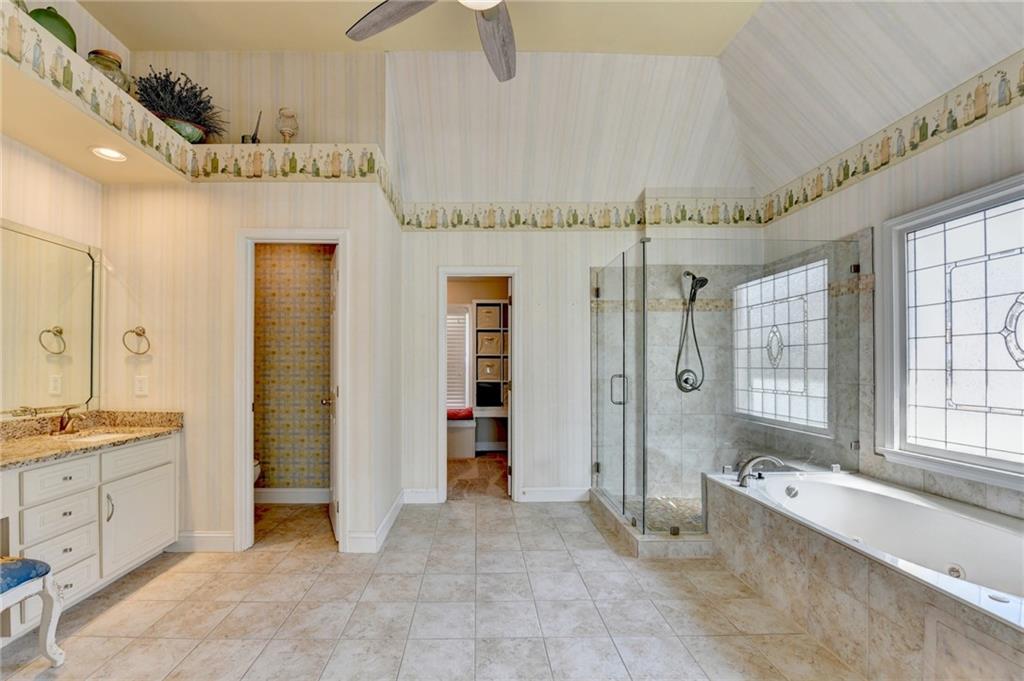 2152 Merrymount Drive Suwanee, GA 30024 - Photo 23 of 63 a spacious bathroom with a granite countertop sink mirror and a bathtub