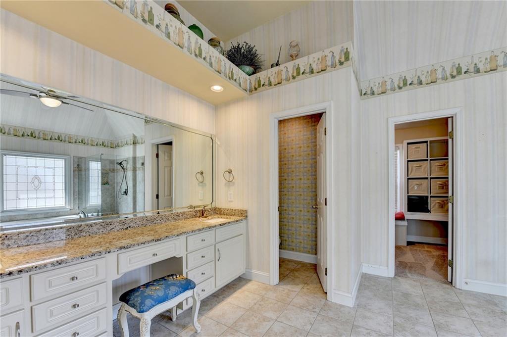 2152 Merrymount Drive Suwanee, GA 30024 - Photo 24 of 63 a spacious bathroom with a granite countertop sink mirror and a shower