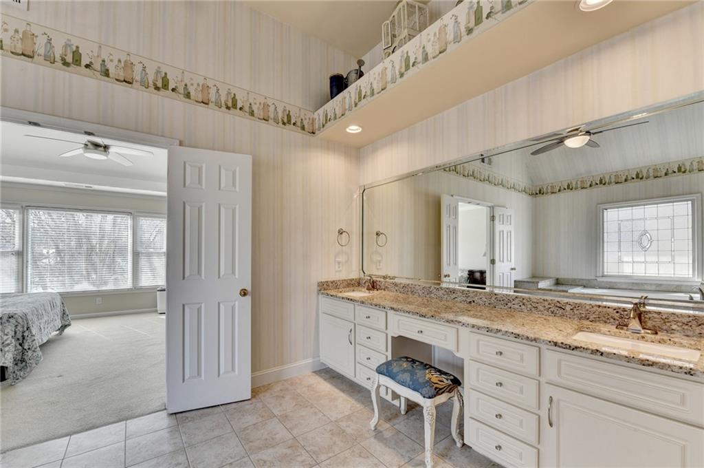 2152 Merrymount Drive Suwanee, GA 30024 - Photo 26 of 63 a bathroom with a granite countertop sink mirror and