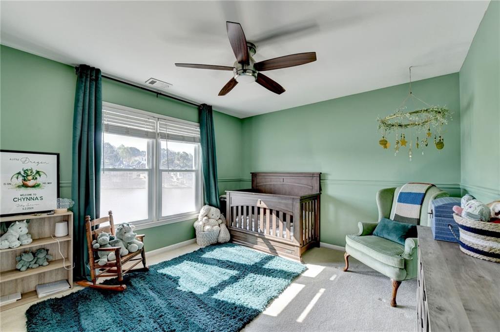 2152 Merrymount Drive Suwanee, GA 30024 - Photo 35 of 63 a bedroom with furniture and a large window