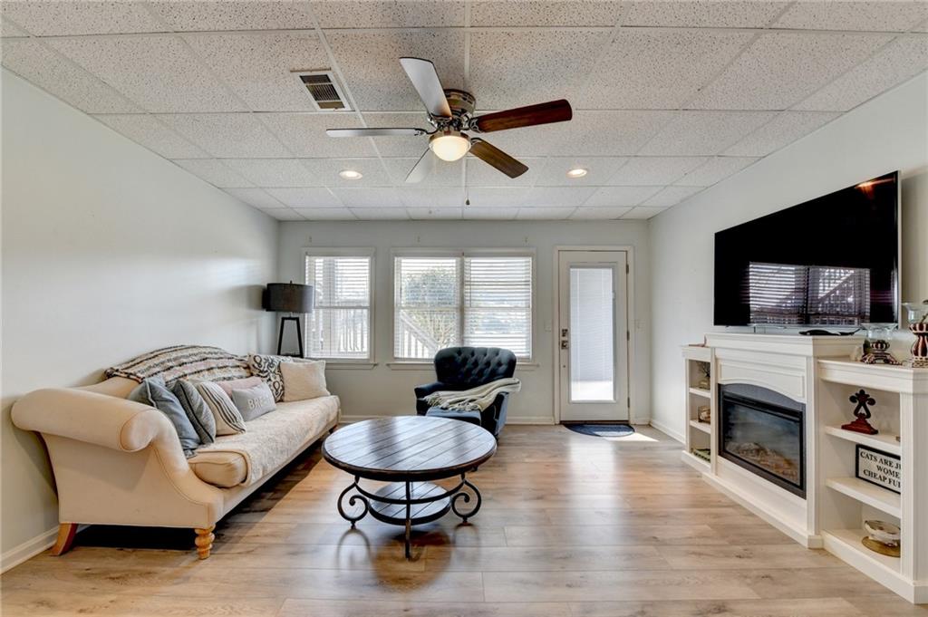 2152 Merrymount Drive Suwanee, GA 30024 - Photo 37 of 63 a living room with furniture and a flat screen tv