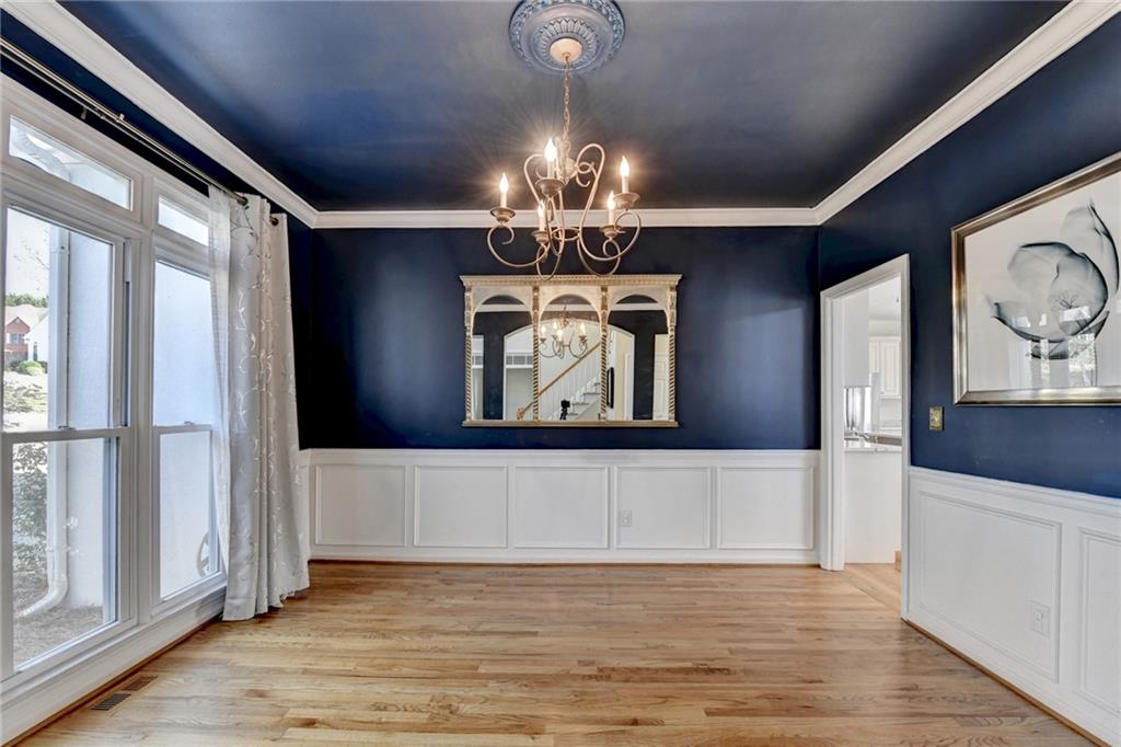 2152 Merrymount Drive Suwanee, GA 30024 - Photo 4 of 63 a view of a livingroom with a chandelier fan and wooden floor
