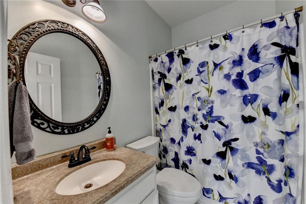 2152 Merrymount Drive Suwanee, GA 30024 - Photo 8 of 63 a bathroom with a sink a toilet and a mirror