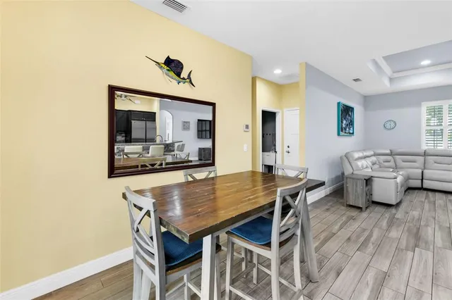 a dining room with furniture and wooden floor