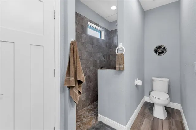 a bathroom with a toilet and a shower