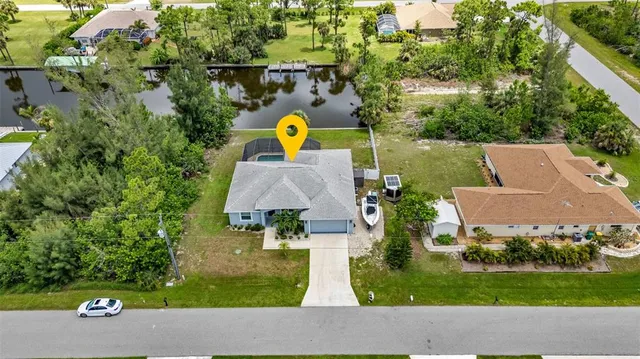 aerial view of a house with swimming pool garden and patio