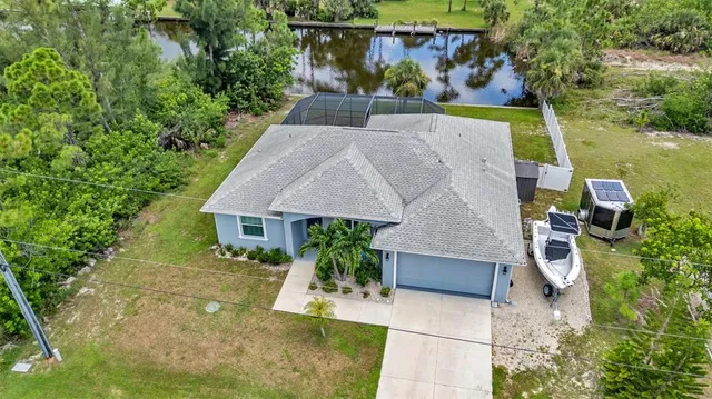 an aerial view of a house with swimming pool and garden
