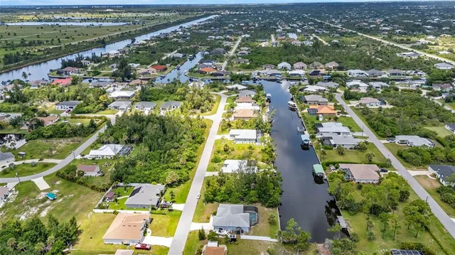 an aerial view of residential houses with outdoor space and street view