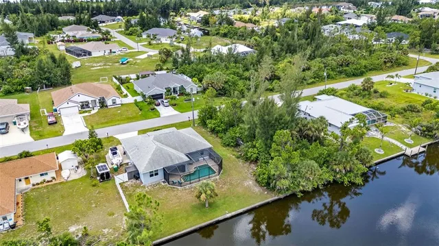an aerial view of a house a yard swimming pool and outdoor seating