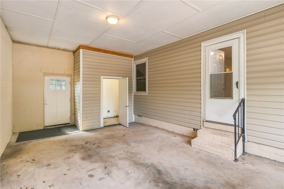 606 Perry Road Greenville, SC 29609 - Photo 18 of 22 Covered concrete carport offers direct entry into the home through multiple access points.