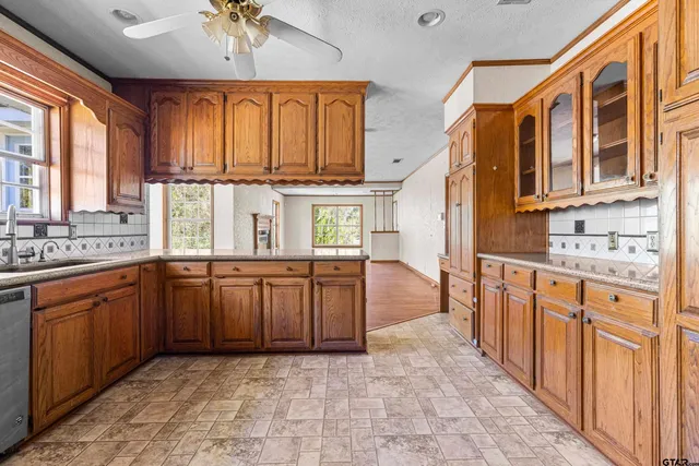 a kitchen with stainless steel appliances granite countertop a sink and cabinets