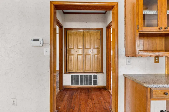 a view of a kitchen from a hallway