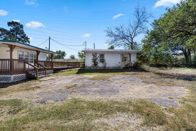 a view of a backyard with wooden fence