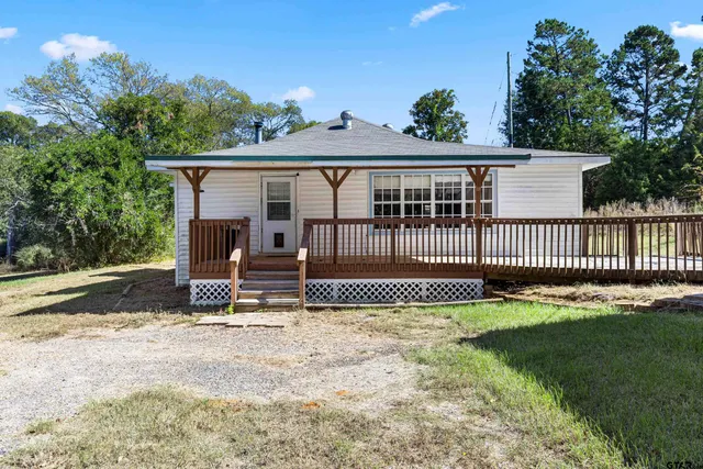 a view of a house with a small yard and plants