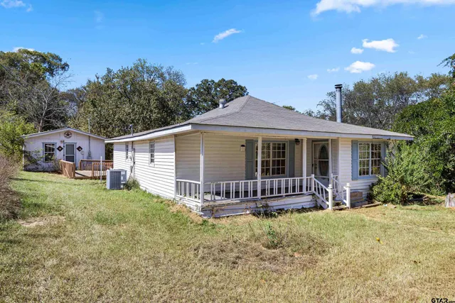 a front view of a house with a garden and porch
