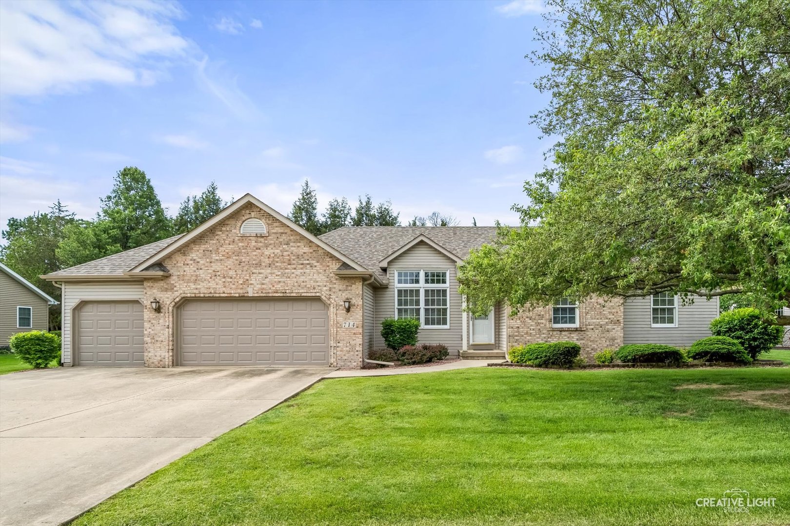 714 East Knights Road Sandwich, IL 60548 - Photo 1 of 33 a front view of a house with a yard and garage