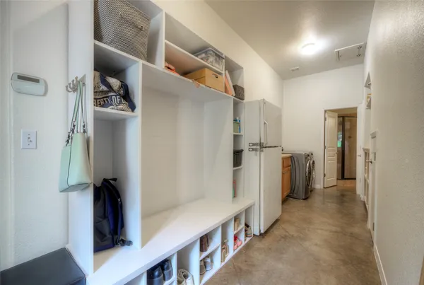 a hallway with white cabinets