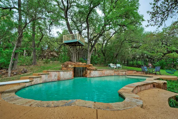 a view of a swimming pool with a patio