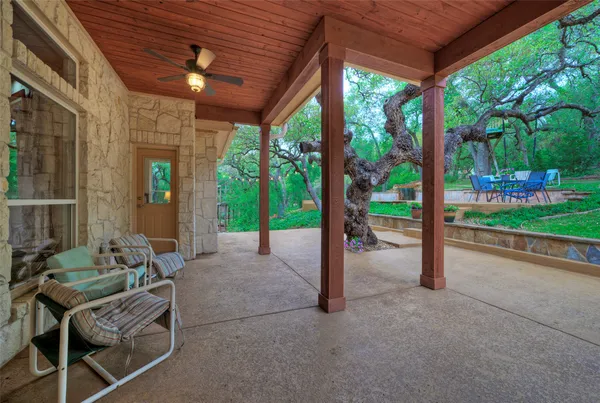 a view of a patio with a table chairs and backyard