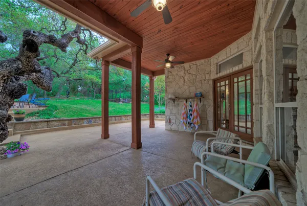 a view of a porch with furniture and a small yard