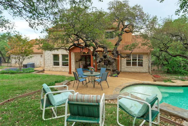 a view of a house with backyard porch and sitting area