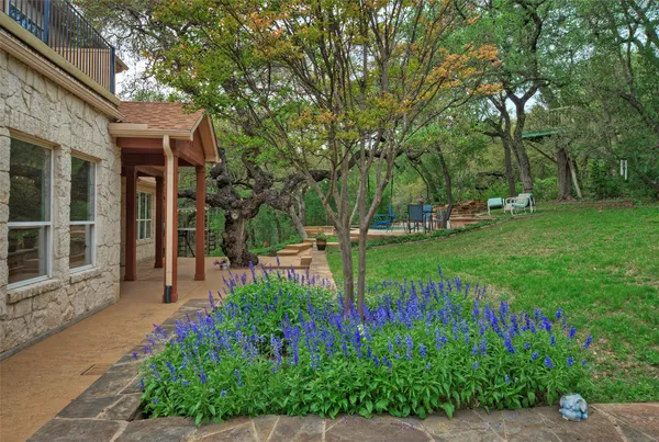 a view of a house with a backyard and a garden