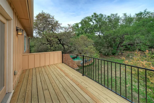 a view of balcony with wooden floor and fence