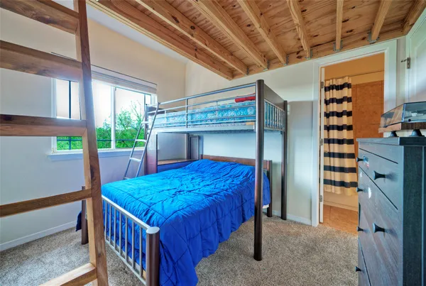 a view of a bedroom with furniture and windows