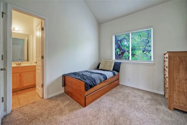 a bedroom with a bed and dresser