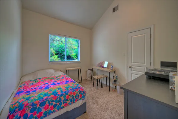 a bedroom with a bed and a table in it