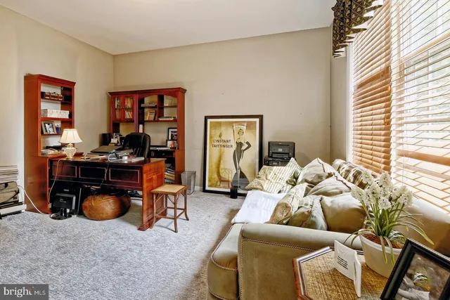 a living room with furniture gym equipment and a window
