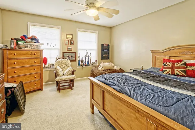 a bed room with a bed and a chair