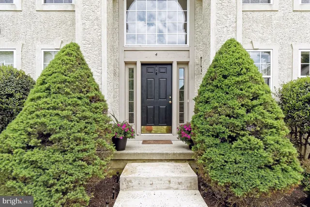 a front view of a house with a yard and plants