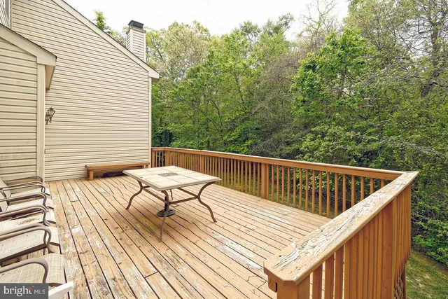 a view of balcony with wooden floor and outdoor seating