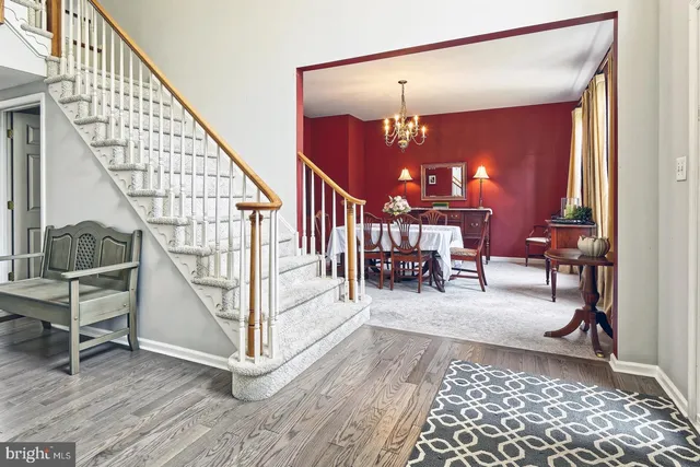 a view of entryway dining room and hall with wooden floor