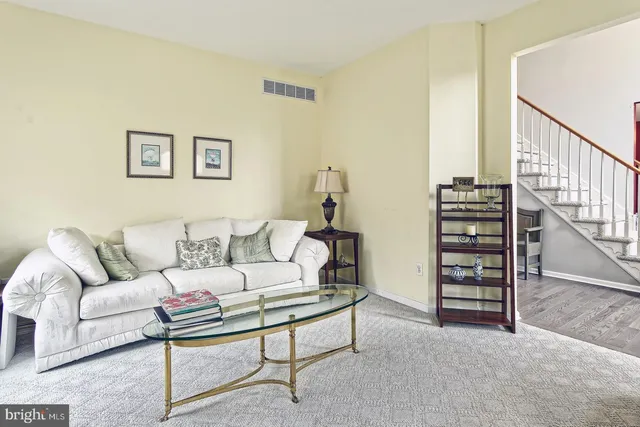 a living room with furniture and a stairs