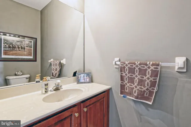 a bathroom with a sink mirror and vanity