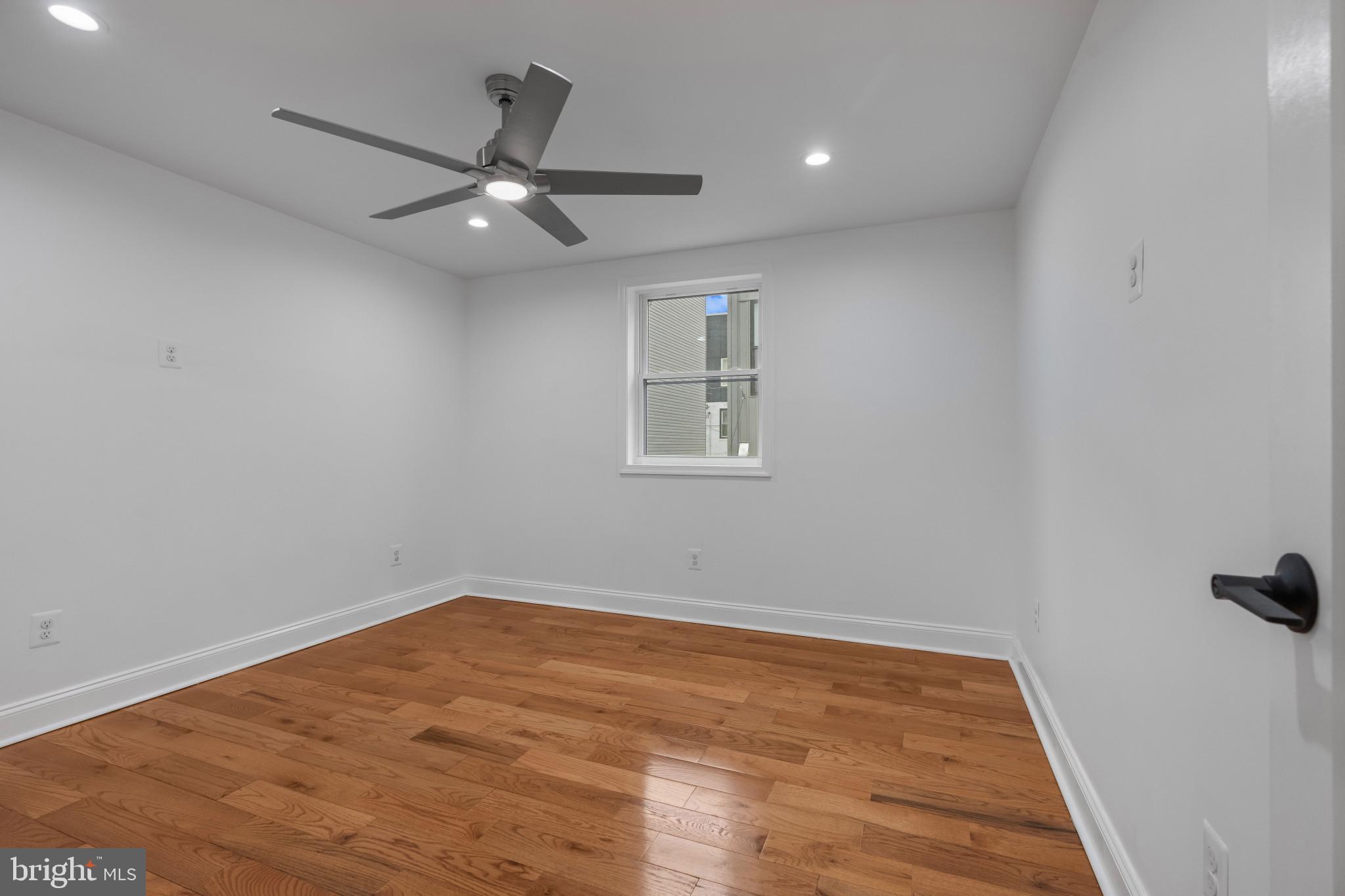 625 Winton Street Philadelphia, PA 19148 - Photo 12 of 25 an empty room with wooden floor and windows