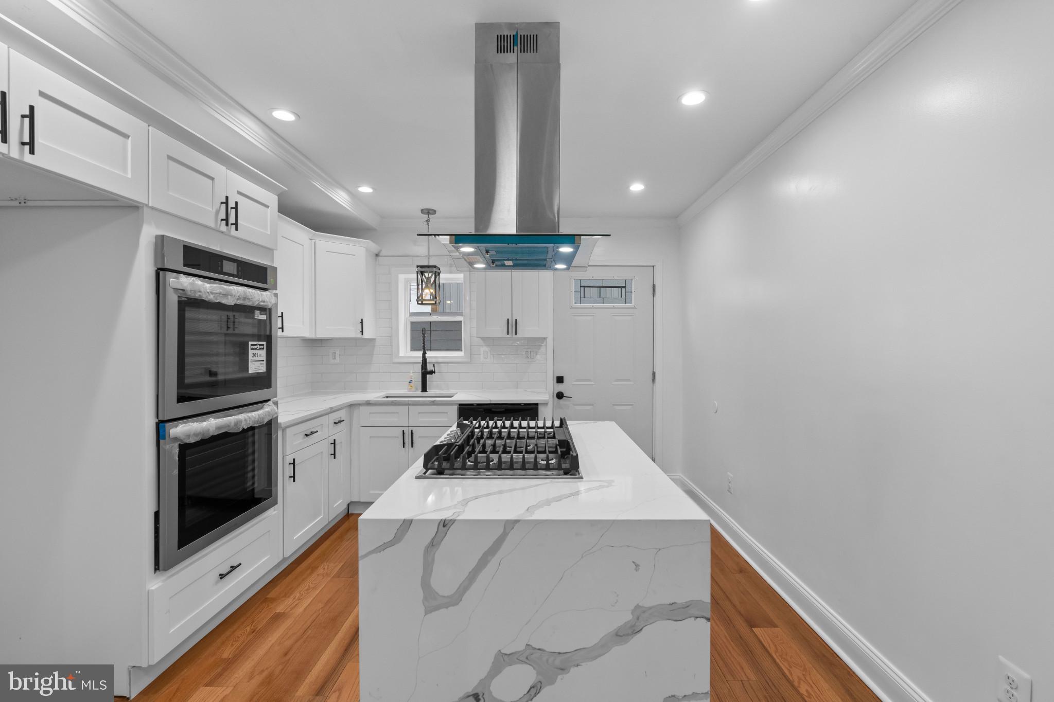 625 Winton Street Philadelphia, PA 19148 - Photo 9 of 25 a kitchen with granite countertop a stove a sink and a refrigerator