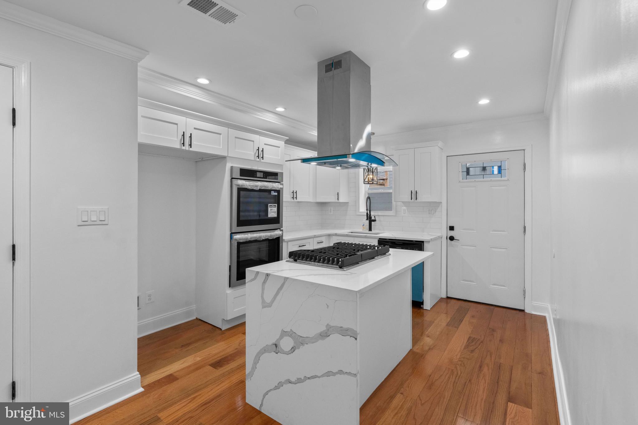 625 Winton Street Philadelphia, PA 19148 - Photo 10 of 25 a kitchen with a stove and a refrigerator