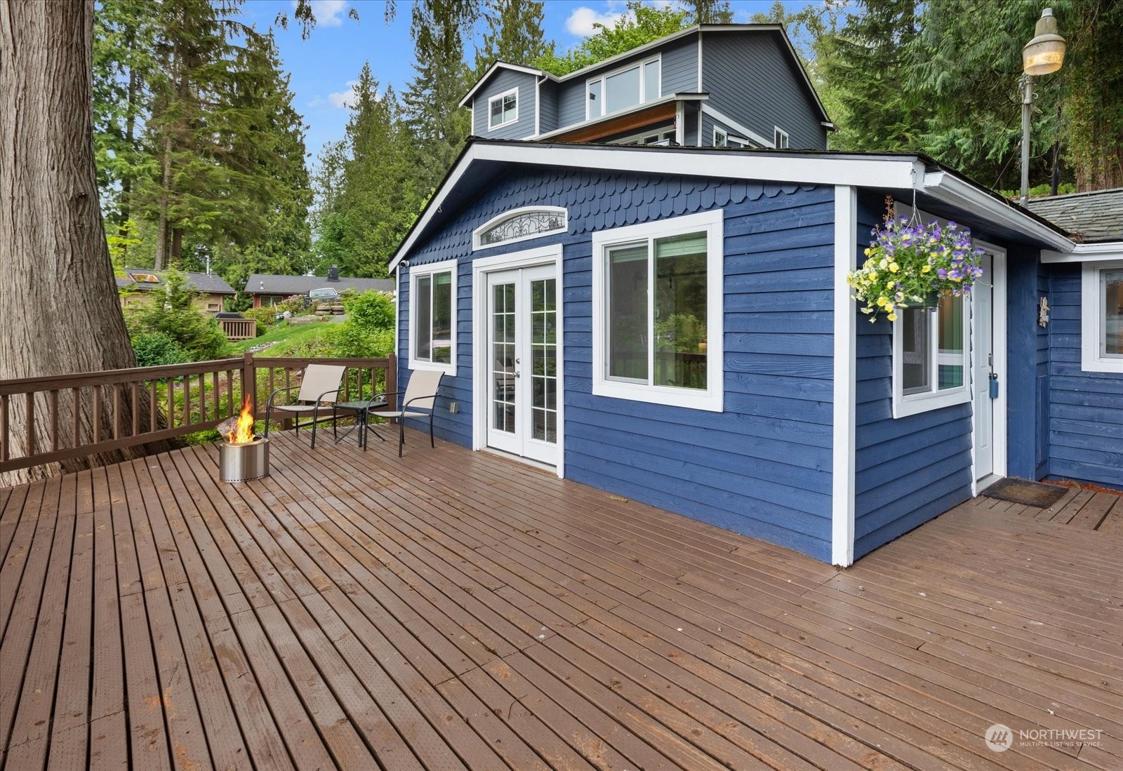 a view of a house with wooden deck front of house
